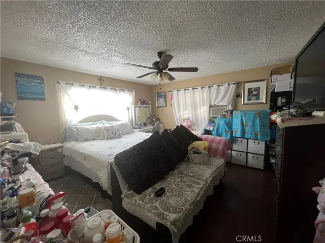 a bedroom with two beds and a flat screen tv