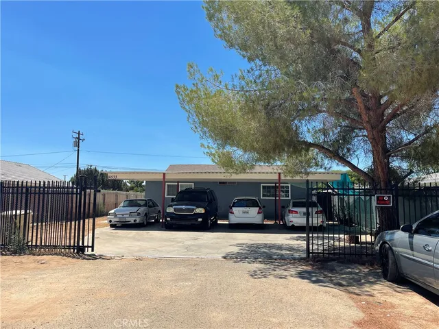a view of a roadside with a bench and trees