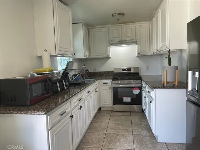 a kitchen with cabinets and white appliances