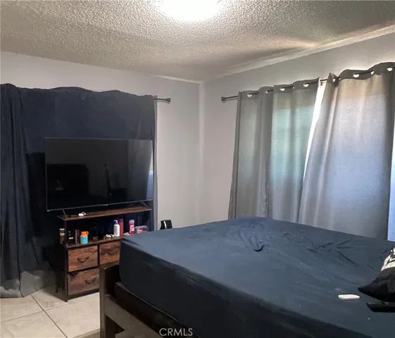 a view of a room with furniture and a flat screen tv