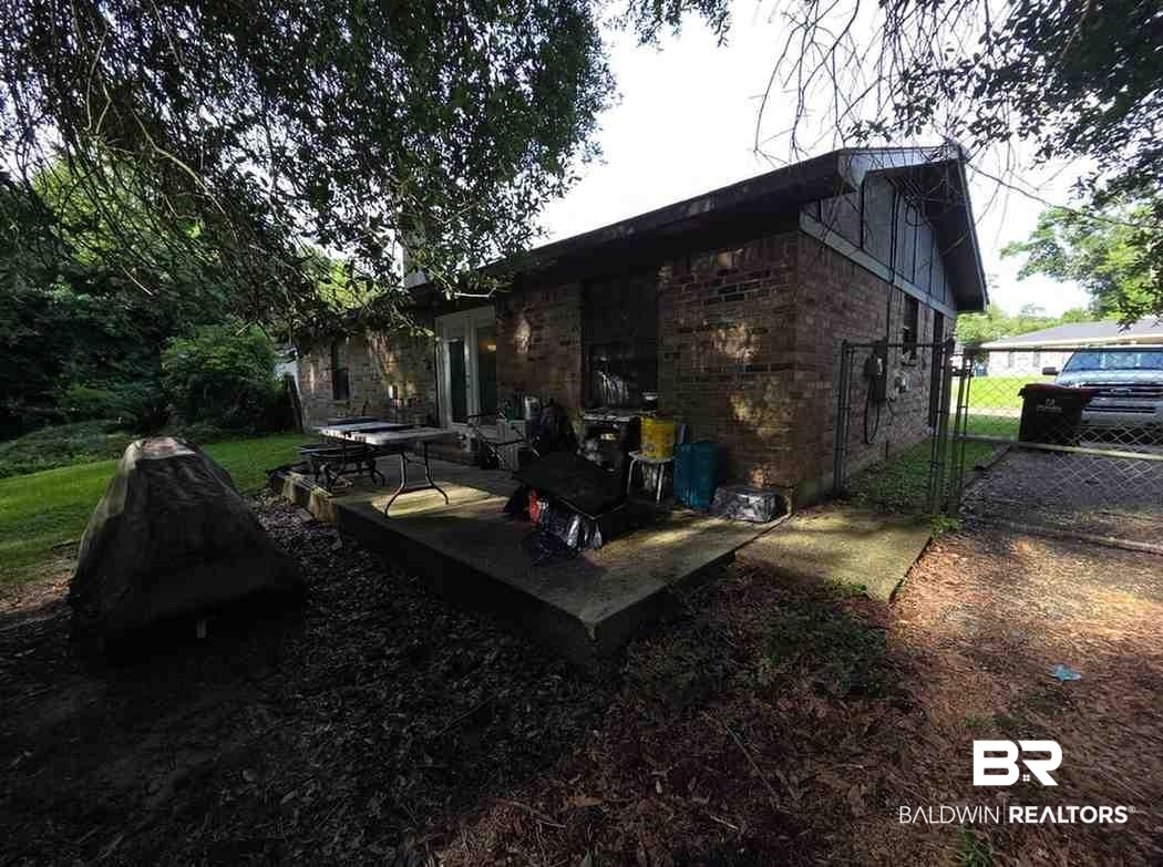 5120 West Celtic Drive Mobile, AL 36619 - Photo 26 of 27 View of side of property with brick siding and a gate