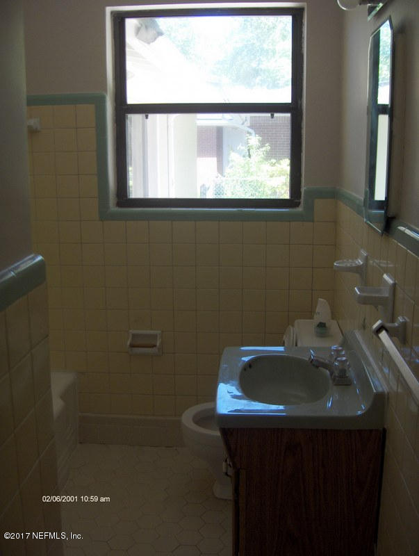 3722 Coronado Road Jacksonville, FL 32217 - Photo 16 of 20 a bathroom with a sink a window and mirror