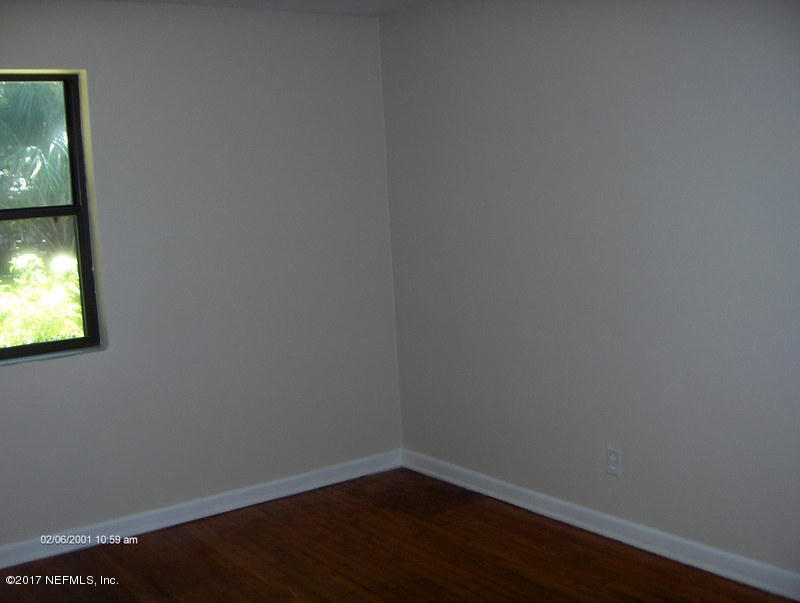 3722 Coronado Road Jacksonville, FL 32217 - Photo 17 of 20 a view of a small space with wooden floor and a window