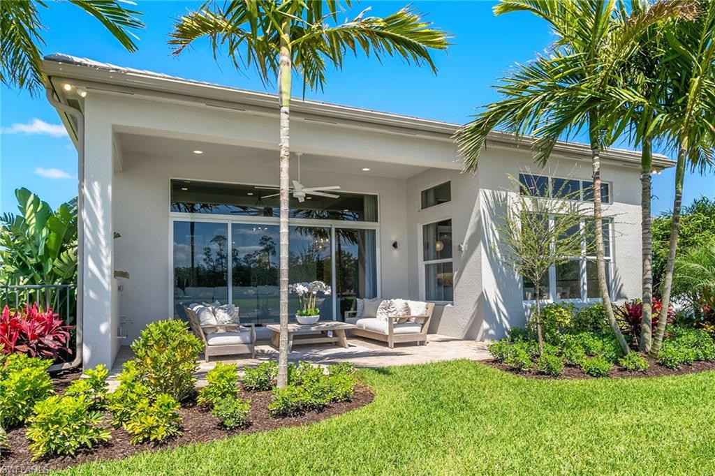 2695 Ridgecrest Place Naples, FL 34112 - Photo 11 of 13 Back of property featuring an outdoor hangout area, a ceiling fan, stucco siding, and a patio