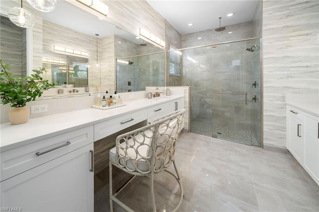 2695 Ridgecrest Place Naples, FL 34112 - Photo 5 of 13 Full bath featuring vanity, a stall shower, and tile walls