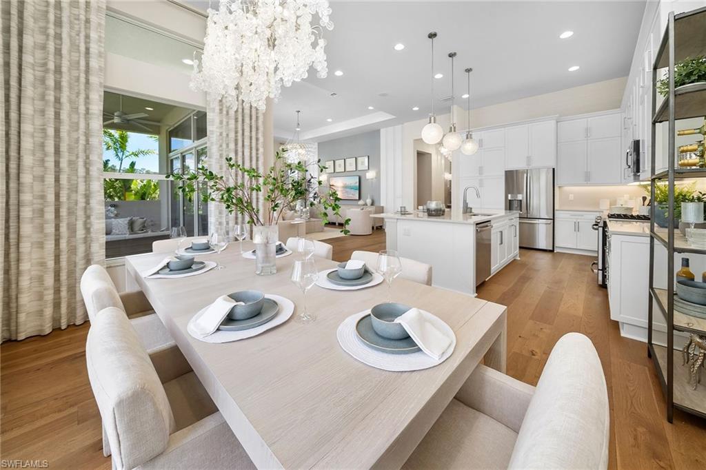 2695 Ridgecrest Place Naples, FL 34112 - Photo 9 of 13 Dining area with light wood-style flooring, recessed lighting, a ceiling fan, and a chandelier