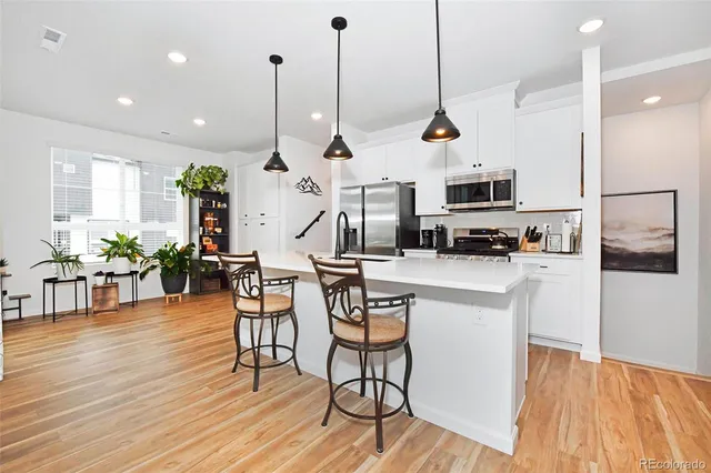 a room with furniture a wooden floor and a chandelier