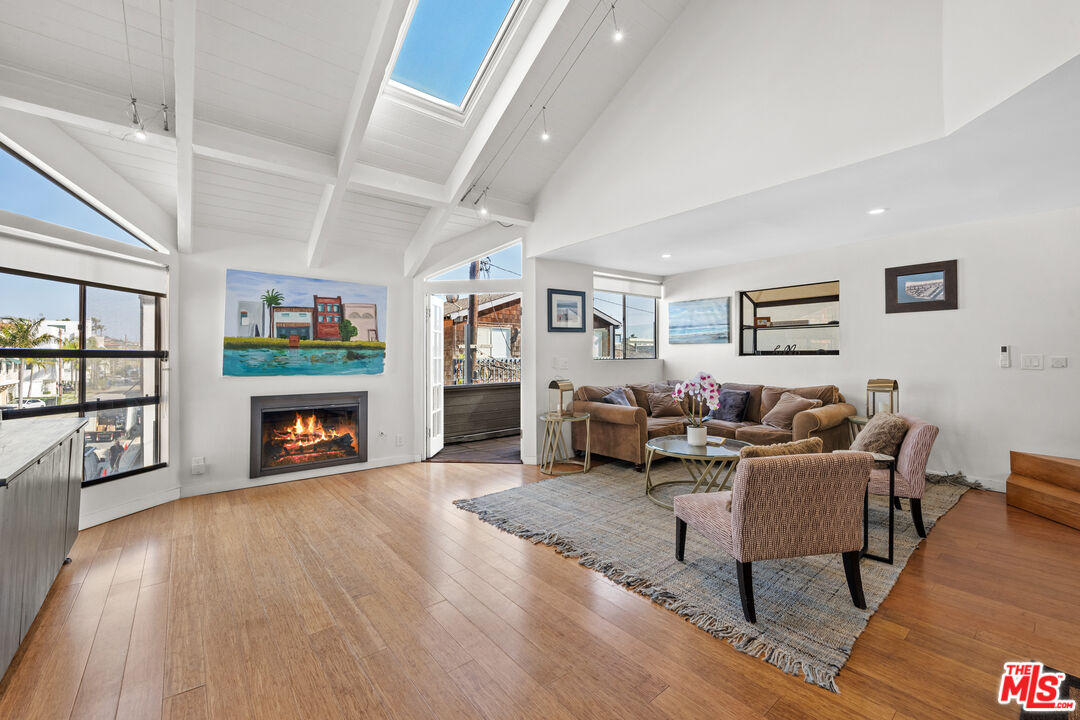 30 Voyage Street Marina del Rey, CA 90292 - Photo 2 of 21 a living room with fireplace furniture and a wooden floor