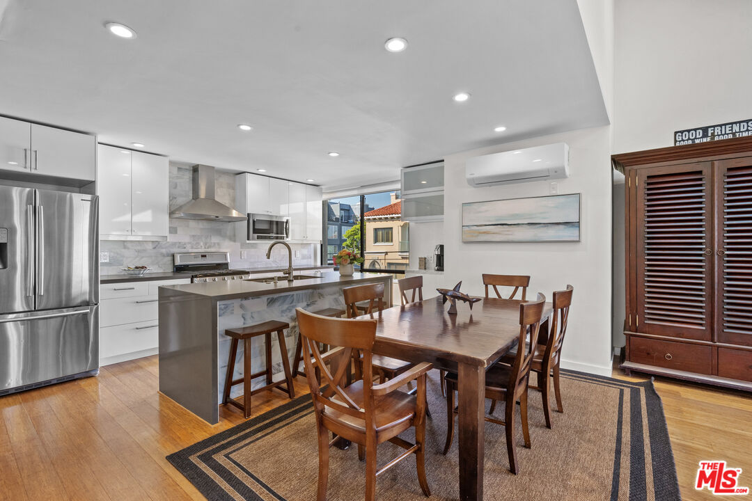 30 Voyage Street Marina del Rey, CA 90292 - Photo 4 of 21 a kitchen with a dining table chairs refrigerator and microwave