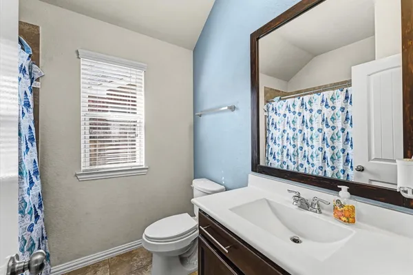 an empty room with closet and windows