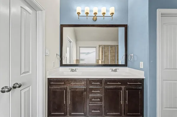 a spacious bathroom with a tub sink and mirror