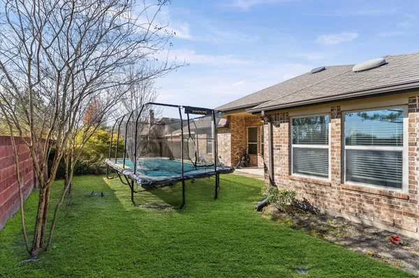a view of house with backyard