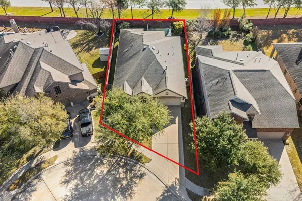 an aerial view of a house with a yard