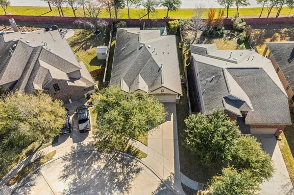 an aerial view of a house with a yard