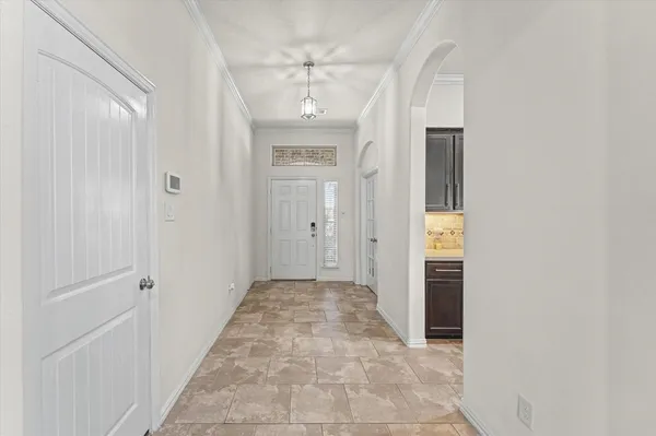 a view of a hallway with wooden floor and a bathroom