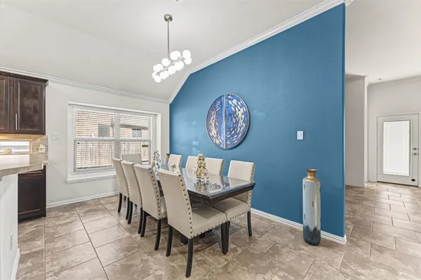 a view of a dining room with furniture and a chandelier