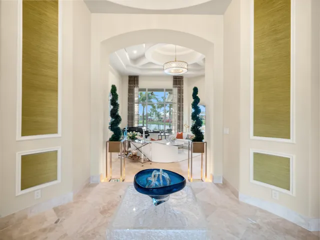a living room with a fireplace and a chandelier