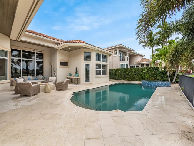 a view of a house with swimming pool and sitting area