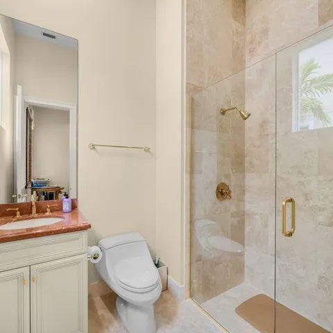 a bathroom with a sink toilet and shower