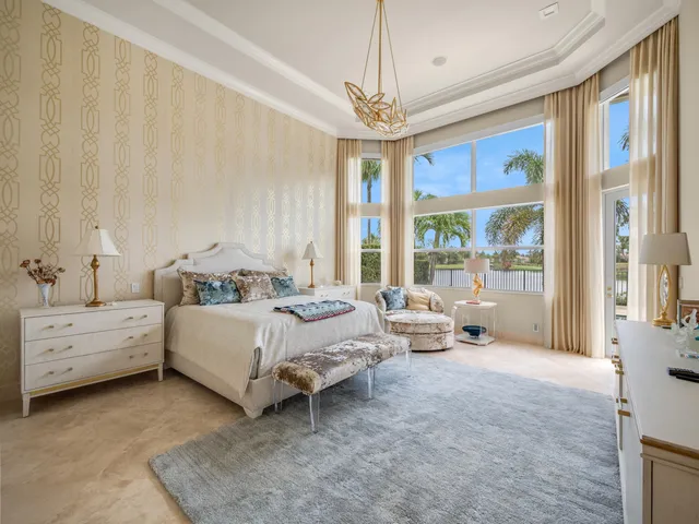 a spacious bedroom with a bed and a chandelier