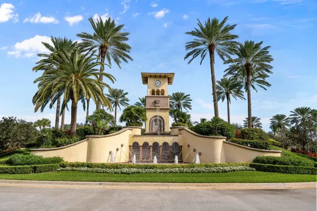 a front view of multi story residential apartment building with yard and green space
