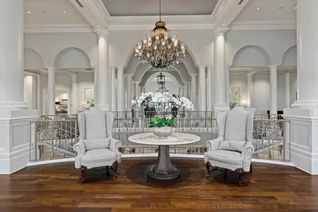 a living room with furniture and a chandelier