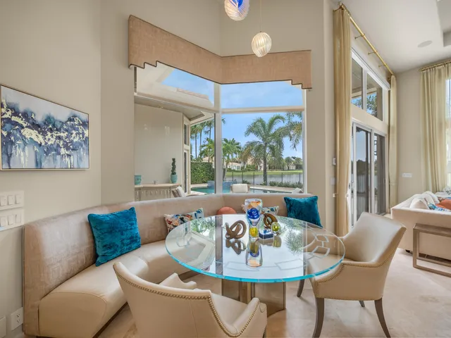 a dining room with furniture and a large window