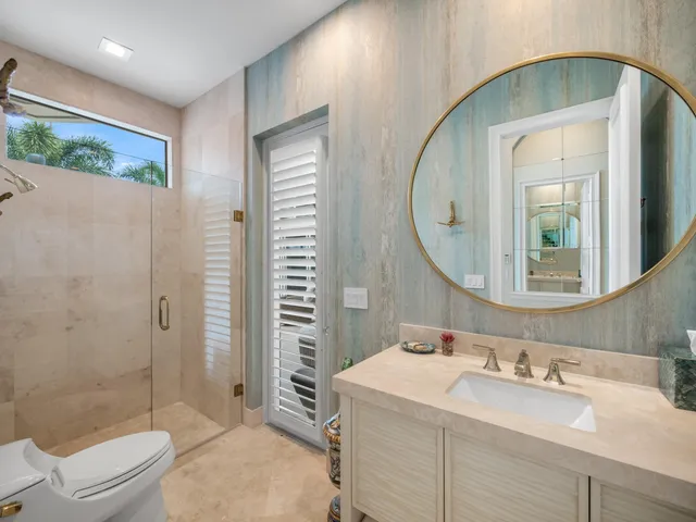 a bathroom with a sink a toilet and a mirror