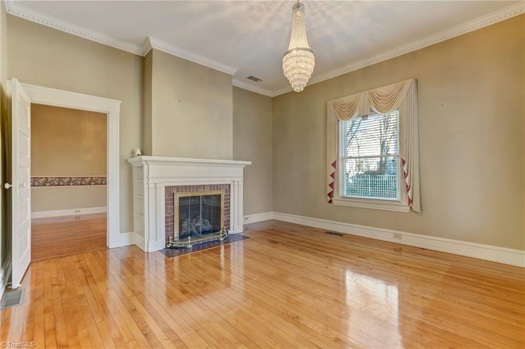 521 Patrick Street Eden, NC 27288 - Photo 8 of 50 Front living room fireplace leading into formal dining room