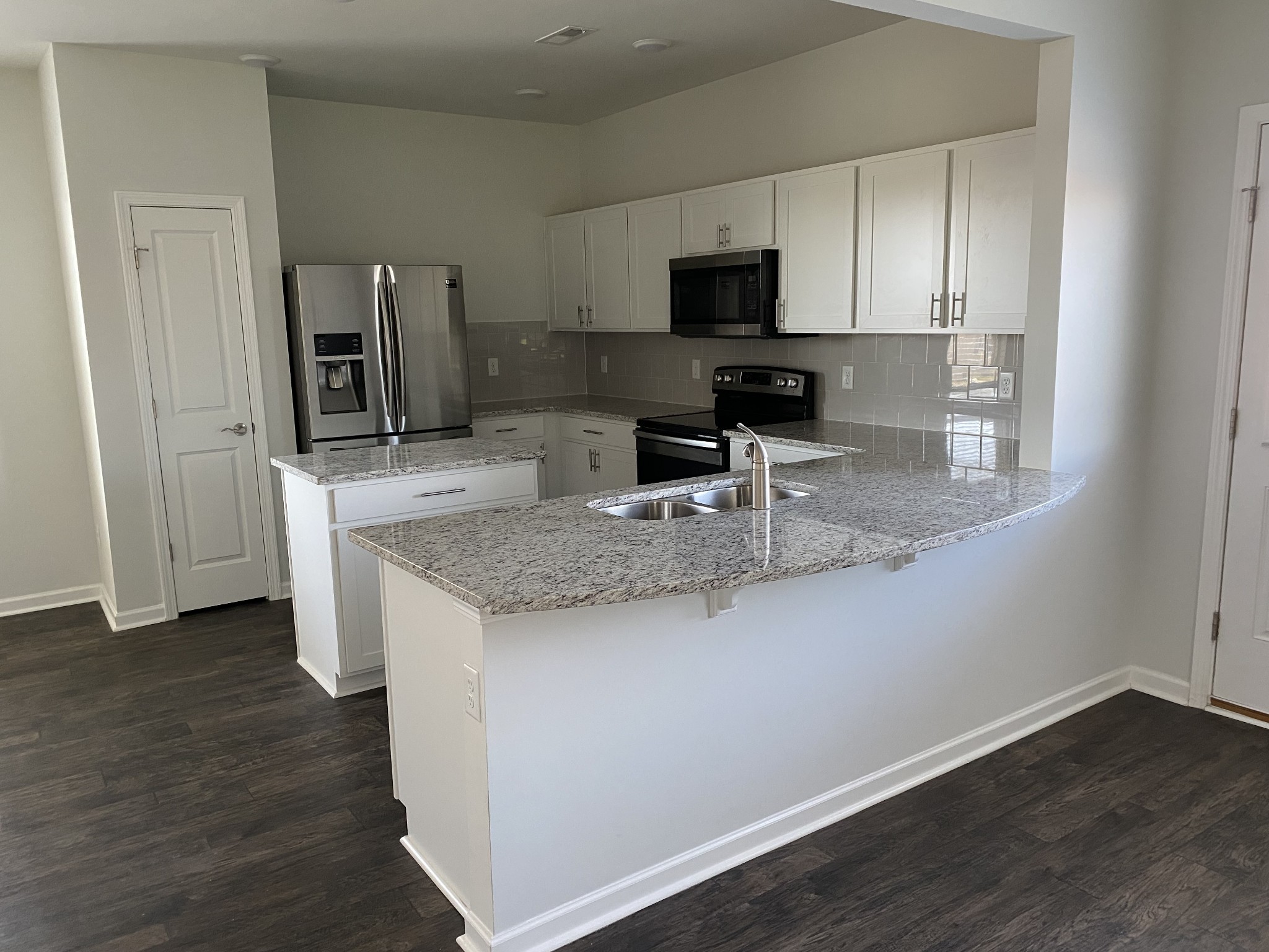 1024 Lonergan Circle Spring Hill, TN 37174 - Photo 2 of 8 a kitchen with stainless steel appliances granite countertop a sink microwave and cabinets