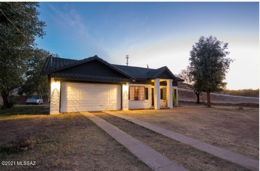 577 Camino Lito Galindo Rio Rico, AZ 85648 - Photo 3 of 19 a front view of a house with a yard and garage