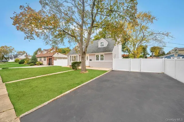 a view of a house with a yard and garage