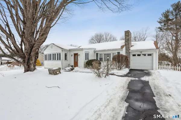 a view of a town with snow on the road