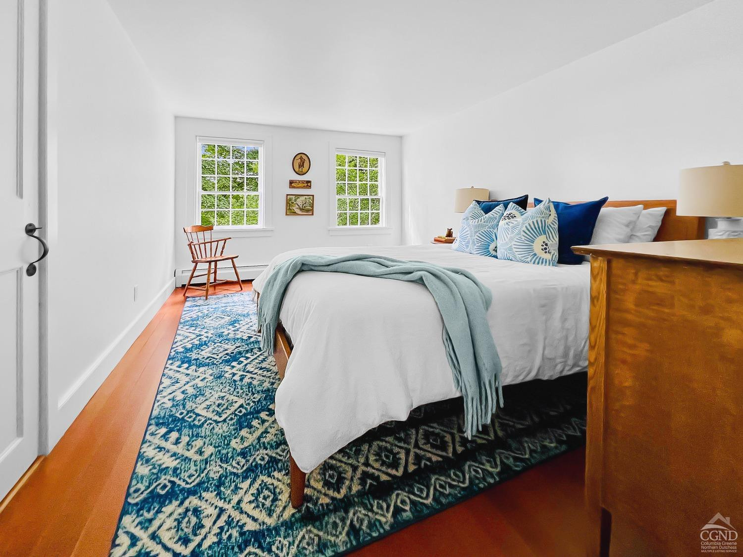 7 Thomas Road Chatham, NY 12184 - Photo 13 of 25 a bed sitting in a bedroom next to a window