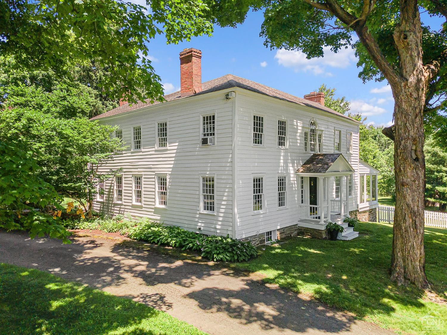 7 Thomas Road Chatham, NY 12184 - Photo 2 of 25 a view of a yard in front of a house with plants and large tree