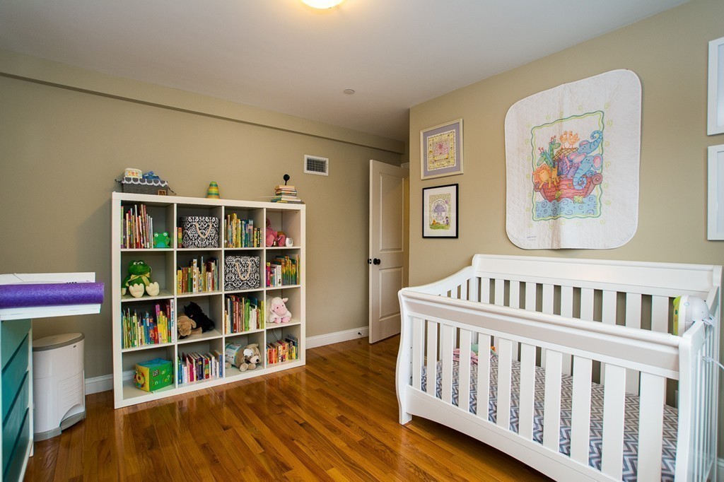 45 Selkirk Road, Unit C Boston, MA 02135 - Photo 12 of 19 a bedroom with furniture and baby crib