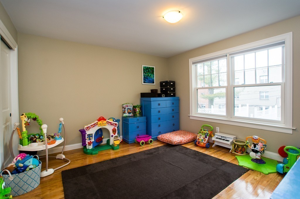 45 Selkirk Road, Unit C Boston, MA 02135 - Photo 14 of 19 a bedroom with bed toys and a window