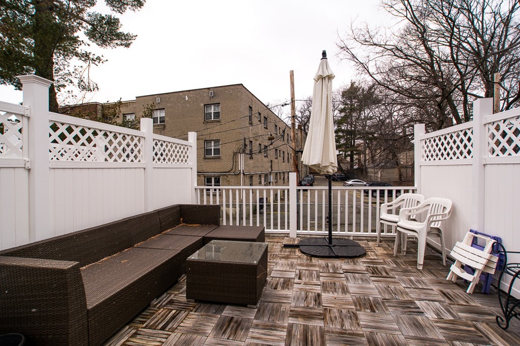 45 Selkirk Road, Unit C Boston, MA 02135 - Photo 18 of 19 a roof deck with a couch and chairs