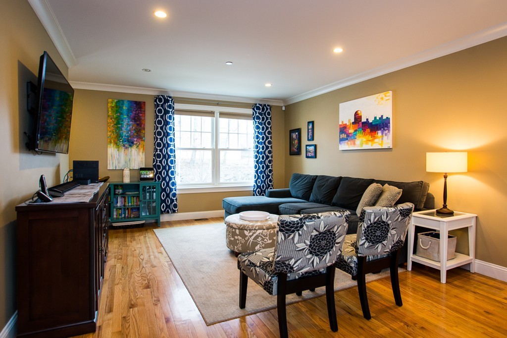 45 Selkirk Road, Unit C Boston, MA 02135 - Photo 2 of 19 a bedroom with a bed and a flat screen tv