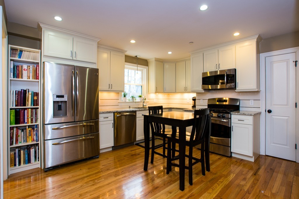 45 Selkirk Road, Unit C Boston, MA 02135 - Photo 7 of 19 a kitchen with stainless steel appliances a refrigerator and a stove top oven
