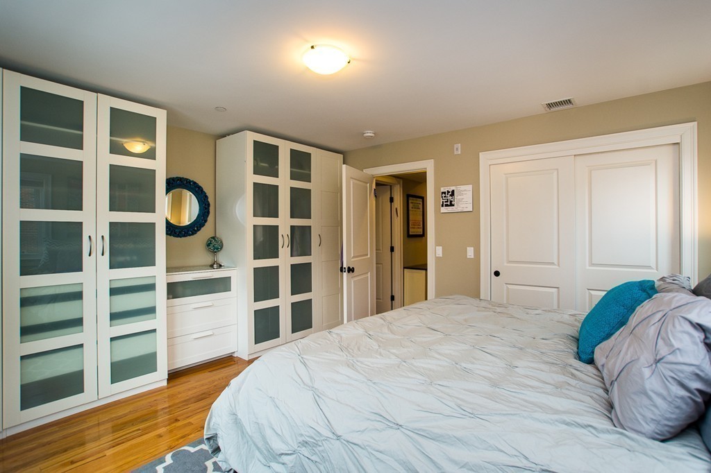 45 Selkirk Road, Unit C Boston, MA 02135 - Photo 10 of 19 a bedroom with a bed and a window