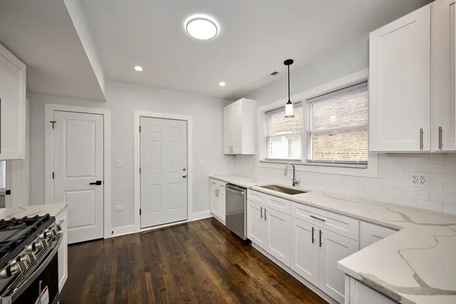 a kitchen with a sink stove and cabinets