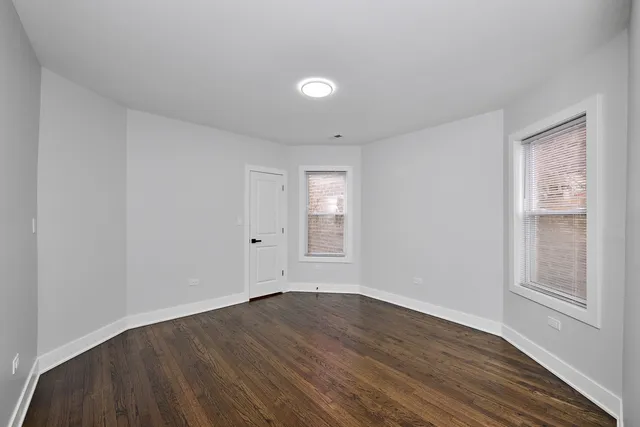 a view of wooden floor and windows in a room