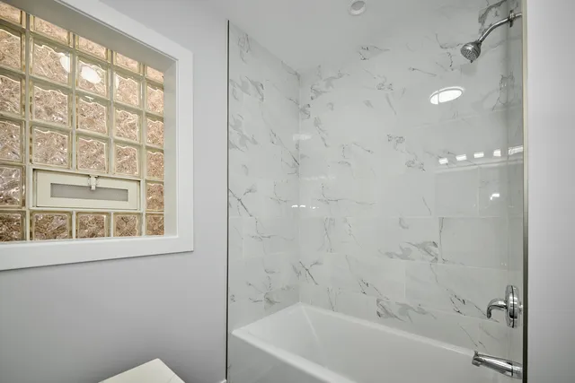 a bathroom with a bathtub and a shower