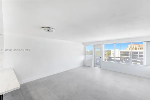 a view of an empty room with a window