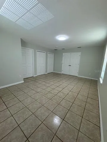 a view of an empty room and a window