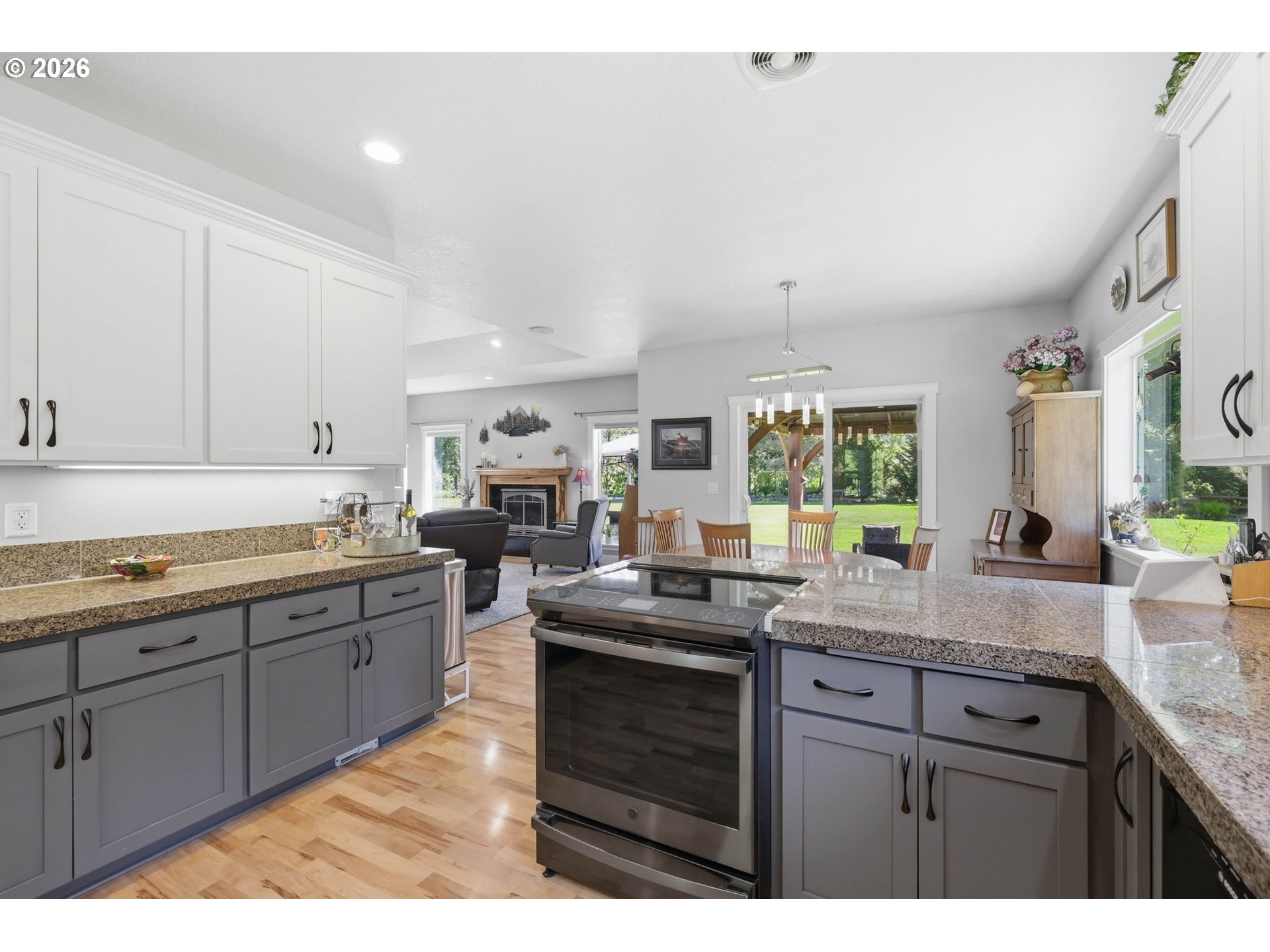 29778 Gimpl Hill Road Eugene, OR 97405 - Photo 12 of 43 a kitchen with granite countertop cabinets stainless steel appliances a sink and a large window