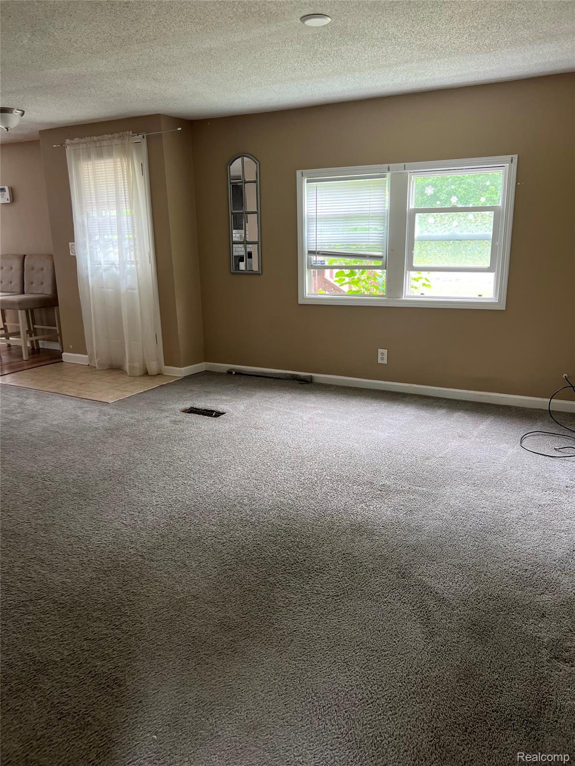 35945 Herman Street Romulus, MI 48174 - Photo 4 of 26 Carpeted empty room featuring a textured ceiling