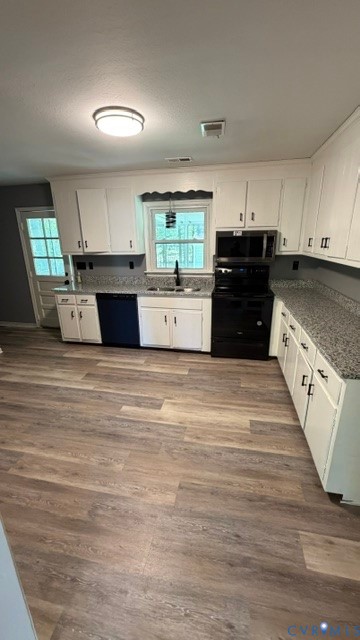 2597 Varney Road Henrico, VA 23231 - Photo 3 of 26 a large white kitchen with wooden floors and white stainless steel appliances