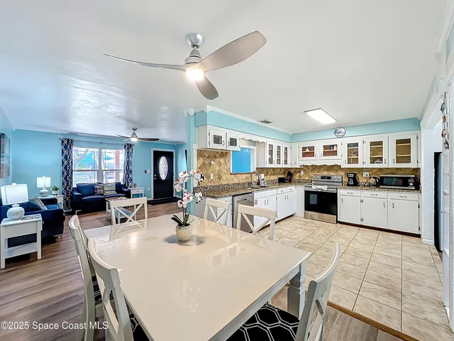 a kitchen with stainless steel appliances kitchen island granite countertop a stove and cabinets